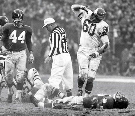 Chuck Bednarik exulting over Frank Gifford